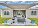 View of a covered back patio with barbecue and seating area overlooking the lawn at 4200 Woodcliffe Dr., Conway, SC 29526