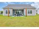 Backyard view of a patio with furniture, barbecue, shade and beautiful lawn at 4200 Woodcliffe Dr., Conway, SC 29526