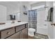 Bathroom with shower-tub, vanity with sink, toilet, and patterned shower curtain at 4200 Woodcliffe Dr., Conway, SC 29526