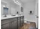 Clean bathroom with double sink vanity, wood floors, and a large well lit mirror at 4200 Woodcliffe Dr., Conway, SC 29526