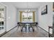 Dining room with modern chandelier, table with chairs, and natural light from the windows at 4200 Woodcliffe Dr., Conway, SC 29526