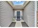 Covered entryway with stylish decor and sidelights, creating a warm welcome to the home at 4200 Woodcliffe Dr., Conway, SC 29526