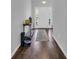 Long hallway with hardwood floors and a console table, offering a clean and organized aesthetic at 4200 Woodcliffe Dr., Conway, SC 29526