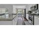 White cabinets, stainless appliances, and granite countertops highlight this kitchen, leading to a dining area at 4200 Woodcliffe Dr., Conway, SC 29526
