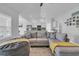 Cozy living room with open floor plan to kitchen, featuring hardwood floors and grey sofa at 4200 Woodcliffe Dr., Conway, SC 29526