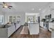 Bright, open-concept living area featuring a kitchen with breakfast bar and comfortable sofa at 4200 Woodcliffe Dr., Conway, SC 29526