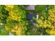 Overhead view of a charming home with a dark roof nestled among lush, mature trees in a quiet neighborhood at 421 Villa Woods Dr., Myrtle Beach, SC 29579