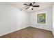 This light-filled bedroom features a ceiling fan, attractive floors, and a window with neighborhood views at 421 Villa Woods Dr., Myrtle Beach, SC 29579
