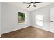 Bright bedroom features a ceiling fan, wood-look flooring, and a window with neighborhood views at 421 Villa Woods Dr., Myrtle Beach, SC 29579