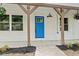 Charming front entrance with a bright blue door, white brick, and pergola adding curb appeal to this lovely home at 421 Villa Woods Dr., Myrtle Beach, SC 29579