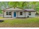 Charming single story home featuring a quaint front porch and a vibrant blue front door at 421 Villa Woods Dr., Myrtle Beach, SC 29579