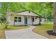 Attractive exterior view with a concrete walkway leading to the delightful blue front door and covered porch at 421 Villa Woods Dr., Myrtle Beach, SC 29579
