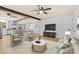 Cozy living room featuring stylish furniture, wood flooring, and open floor plan to the kitchen and dining area at 421 Villa Woods Dr., Myrtle Beach, SC 29579