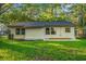 An ample yard, black roof and neutral trim are seen on the back of the property at 421 Villa Woods Dr., Myrtle Beach, SC 29579
