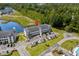 Aerial view of the property with lush landscaping, a tranquil pond, and ample parking spaces at 4503 W Harbour Ct. # S9, Little River, SC 29566