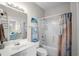 Bathroom showcasing a vanity, toilet, and shower-tub combo with calming beach-themed decor at 4503 W Harbour Ct. # S9, Little River, SC 29566