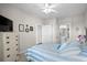 Bright bedroom featuring comfy bed with blue and white striped bedding, TV, and bathroom access at 4503 W Harbour Ct. # S9, Little River, SC 29566
