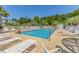 Inviting community pool with ample lounge chairs, palm trees, and various amenities for residents at 4503 W Harbour Ct. # S9, Little River, SC 29566