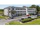 Attractive condo building with neat landscaping, ample parking, and a view of the lake from the parking lot at 4503 W Harbour Ct. # S9, Little River, SC 29566