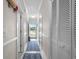 Neutral-toned hallway with a blue patterned rug and white doors at 4503 W Harbour Ct. # S9, Little River, SC 29566