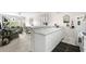 Bright kitchen with white cabinets and appliances offering an open view to the living area at 4503 W Harbour Ct. # S9, Little River, SC 29566