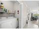 Well-lit laundry room with a washer, dryer, and shelving for storage, adjacent to the living area at 4503 W Harbour Ct. # S9, Little River, SC 29566