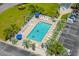 Aerial view of community pool surrounded by palm trees and lounge chairs on a sunny day at 4503 W Harbour Ct. # S9, Little River, SC 29566