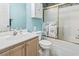 Cozy bathroom featuring blue walls, a shower with glass doors, and a storage cabinet above the toilet at 4616 Greenbriar Dr. # H-4, Little River, SC 29566