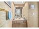 Half bathroom featuring textured wallpaper, a vanity with storage, and a mirror at 4616 Greenbriar Dr. # H-4, Little River, SC 29566