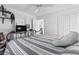 Comfortable bedroom with a striped comforter, ceiling fan, dresser, and access to a bathroom at 4616 Greenbriar Dr. # H-4, Little River, SC 29566
