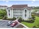 Exterior daytime image of building with lush green landscaping and parking at 4616 Greenbriar Dr. # H-4, Little River, SC 29566