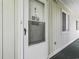 Close-up of entryway featuring door #4, screen and light green siding at 4616 Greenbriar Dr. # H-4, Little River, SC 29566