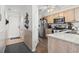Hallway connecting to the kitchen, featuring wood floors, beadboard paneling, and a view into the kitchen at 4616 Greenbriar Dr. # H-4, Little River, SC 29566