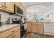 Kitchen with wood cabinets, stainless steel appliances, white countertops, and a view to the living area at 4616 Greenbriar Dr. # H-4, Little River, SC 29566