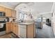 Open-concept kitchen with light wood cabinets offering a view into the adjacent living room at 4616 Greenbriar Dr. # H-4, Little River, SC 29566