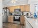 Traditional kitchen featuring stainless steel appliances and light wood cabinetry for ample storage at 4616 Greenbriar Dr. # H-4, Little River, SC 29566