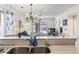 Bright kitchen with stainless steel sink, a view of the chandelier, and a peak into the living room at 4616 Greenbriar Dr. # H-4, Little River, SC 29566