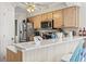 Charming kitchen with light wood cabinets, stainless steel appliances, and a breakfast bar with seating at 4616 Greenbriar Dr. # H-4, Little River, SC 29566