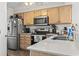 Kitchen with stainless steel appliances, wood cabinets, and a sink overlooking the countertop at 4616 Greenbriar Dr. # H-4, Little River, SC 29566