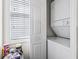 Convenient laundry area with stacked washer and dryer near a bright window at 4616 Greenbriar Dr. # H-4, Little River, SC 29566