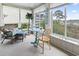 Bright sunroom with wicker furniture, a small table, nautical decorations, and a view of the water at 4616 Greenbriar Dr. # H-4, Little River, SC 29566