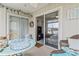 Inviting sunroom with a water view, wicker furniture, and sliding doors to the interior at 4616 Greenbriar Dr. # H-4, Little River, SC 29566