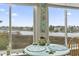 Sunroom table with a lovely water view, nautical decor, and natural light shining through the window at 4616 Greenbriar Dr. # H-4, Little River, SC 29566