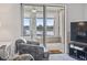Serene sunroom with water views, cozy seating, and access to the outdoors at 4616 Greenbriar Dr. # H-4, Little River, SC 29566