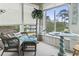 Cozy sunroom featuring wicker seating, beach-themed decor, and large windows offering natural light and outdoor views at 4616 Greenbriar Dr. # H-4, Little River, SC 29566