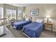 Inviting bedroom with two beds, a desk, and lots of natural light streaming in from two large windows at 4878 Luster Leaf Circle # 402, Myrtle Beach, SC 29577