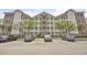 A charming building exterior with brick and white columns that enhance the appeal of the property and its architecture at 4878 Luster Leaf Circle # 402, Myrtle Beach, SC 29577