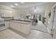 The kitchen opens to the main living areas and features modern appliances, white cabinets, and lots of counter seating at 4878 Luster Leaf Circle # 402, Myrtle Beach, SC 29577