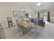 A view from the dining area into an open living room, which features ample light, neutral colors, and access to a patio at 4878 Luster Leaf Circle # 402, Myrtle Beach, SC 29577