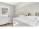 Functional laundry room with washer, dryer, wire rack, and a door to the outside at 505 Forestbrook Dr., Myrtle Beach, SC 29579